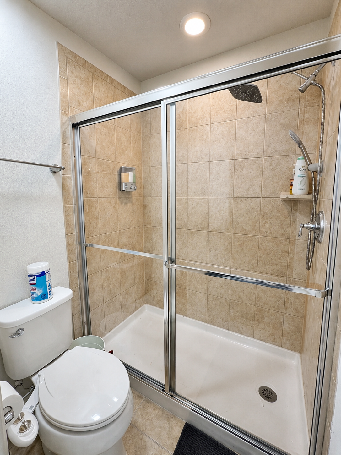 Clean modern bathroom with walk-in shower and chrome fixtures
